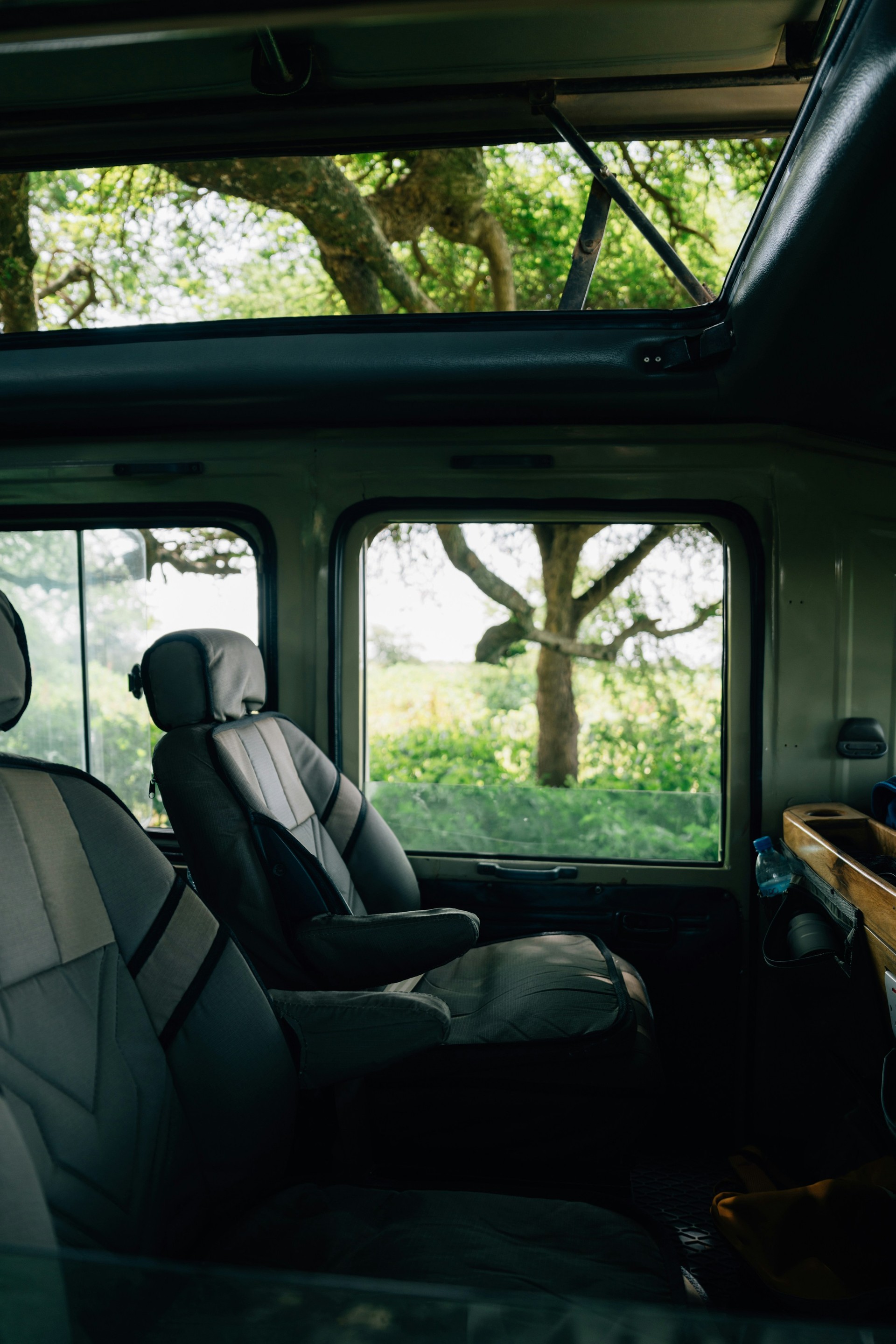Interior of a safari vehicle with open viewing roof for wildlife safaris in Tanzania