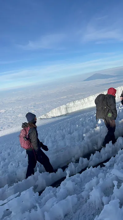 Trekkers navigating icy terrain near the summit glacier of Mount Kilimanjaro